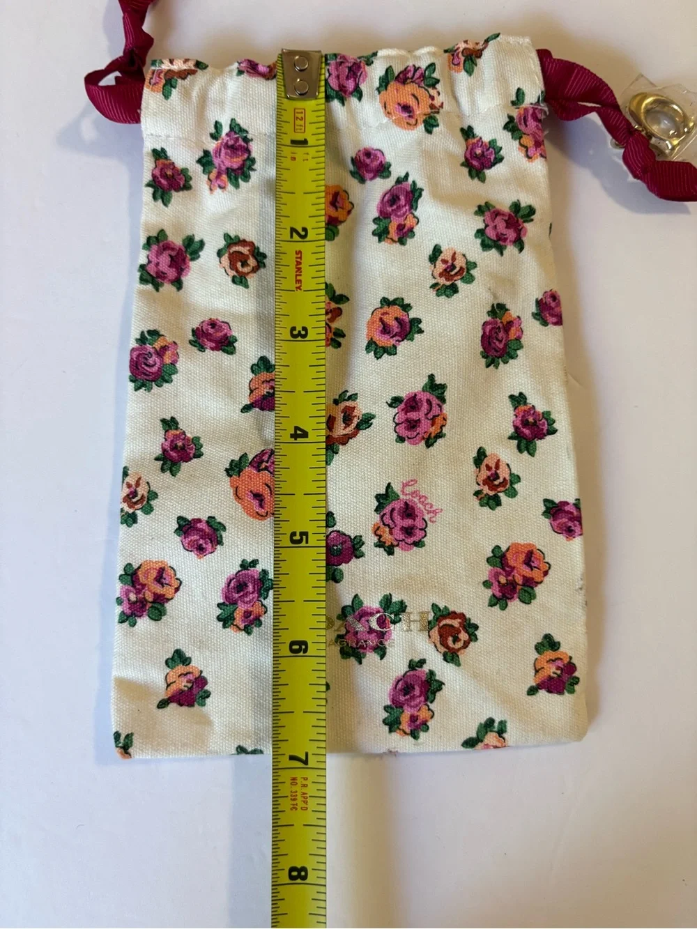 Coach Floral Drawstring Pouch in Cream with Pink & Orange Roses